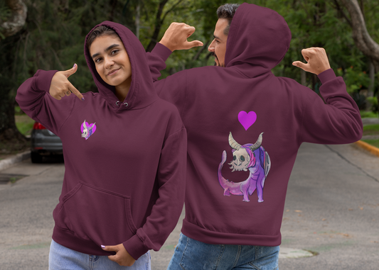 Two people in maroon hoodies, showing front and back designs on the left facing camera showing a heart with a horned creature sticking its head through the heart.  on the the right back to camera showing full graphic of purple horned salamander type creature heart above creatures head